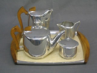 A 1950's 5 piece stainless steel tea service comprising twin handled tray, teapot, hotwater jug, lidded sugar bowl and cream jug