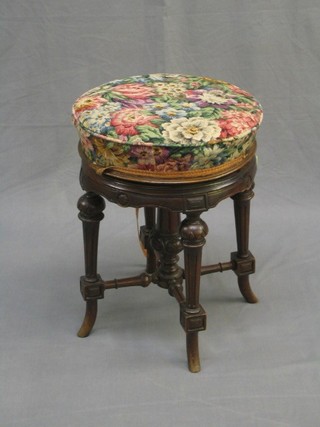 A Victorian circular carved walnut adjustable piano stool (f)