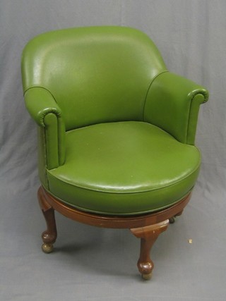 A 1940's walnut framed revolving office chair upholstered in green leatherette