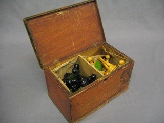 A turned wooden chess set contained in a wooden box