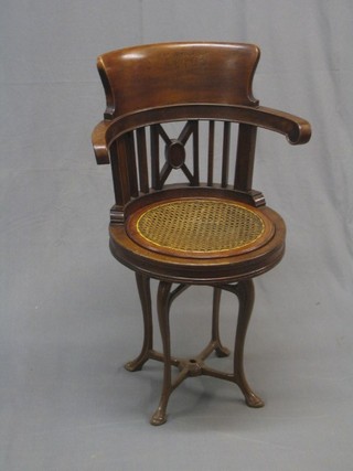 A 19th Century mahogany ships captain's chair with reversible seat, raised on an iron base