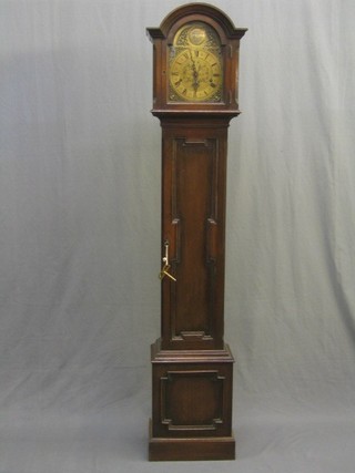 An 8 day chiming Granddaughter clock by Mappin & Webb, the 7" arched dial with Roman numerals and gilt metal spandrels, contained in an oak case 66"