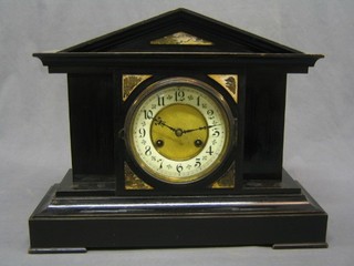 A Victorian 8 day striking mantel clock with enamelled dial and Arabic numerals contained in a black wooden architectural case