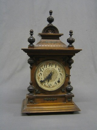 A 19th Century 8 day Continental striking bracket clock contained in a carved walnut case