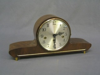 A 1950's German 8 day chiming mantel clock with silvered dial and Arabic numerals contained in a walnut finished case