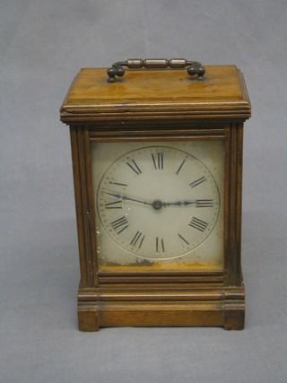 A Victorian mantel clock with 3 1/2" silvered dial having Arabic numerals and contained in a walnut case