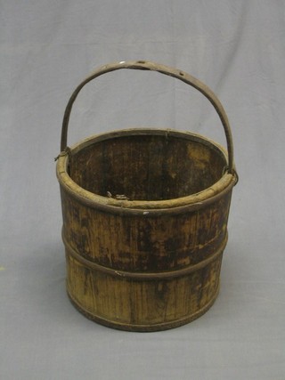 A circular Eastern wooden and iron bucket 16"