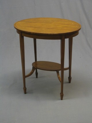 An Edwardian oval satinwood occasional table with inlaid ebony stringing, raised on square tapering supports ending in spade feet and with undertier 25"