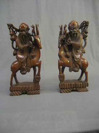 A pair of 19th/20th Century carved Eastern figures of horseman 16"