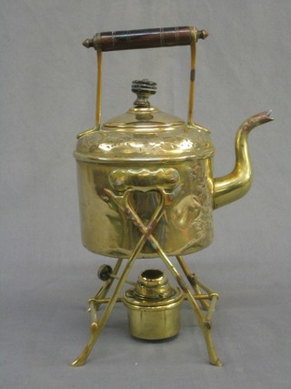 A brass spirit kettle and stand complete with burner