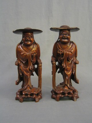 A pair of Eastern carved hardwood figures of standing sages with Coolie hats 50" (1 hat f)