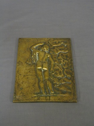 A brass plaque in the form of a standing naked lady 9" x 7"