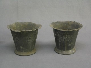 A pair of Tudric Art Nouveau waisted pewter vases with stylised flowers, the base marked Made in England Tudric 0527 4, 4" (some damage and corrosion to both)