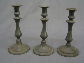 A pair of 19th Century pewter candlesticks with ejectors 9" (1 base f and r) and 1 other pewter candlestick