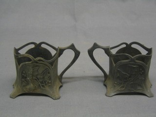 A pair of pierced WMF glass holders decorated holly, the base marked 358 (somewhat corroded)