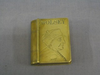 An 18th/19th Century brass snuff box in the form of a book with hinged lid, the lid decorated a portrait of Cardinal Wolsey 2 1/2"
