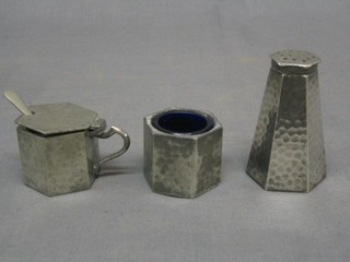 An Art Deco planished pewter 3 piece condiment set of octagonal form comprising mustard, pepper and salt, the base marked Connell 83 Cheapside and marked 634