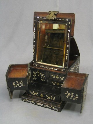 A 19th/20th Century Eastern vanity cabinet with hinged lid fitted a rectangular plate mirror, the interior fitted drawers and compartments, inlaid mother of pearl throughout and with gilt metal mounts 10"