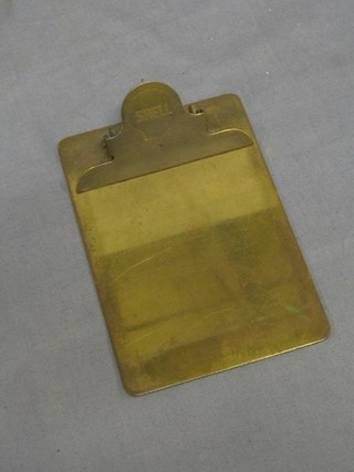 A 1920's rectangular brass clip board, the bull dog clip marked Shell 6" x 4"