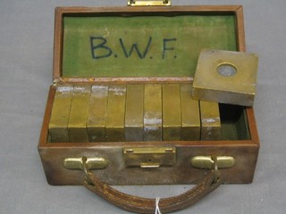 10 - 11lbs square brass test weights marked â€œProperty of W & T Avery Birmingham 11lbs test weightâ€, contained in a leather carrying case