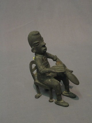 A bronze figure of a seated native 5"