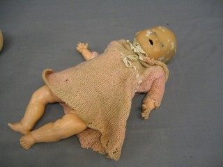 A British made porcelain doll with open mouth, the reverse marked British, with articulated limbs