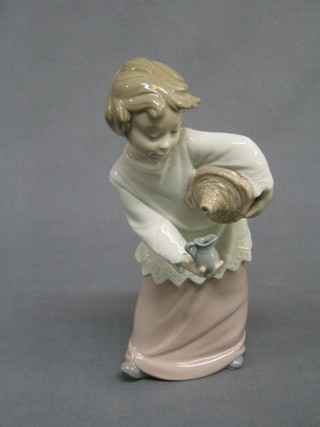 A Nao figure of an altar boy with wine and jug, the base marked Nao 9"