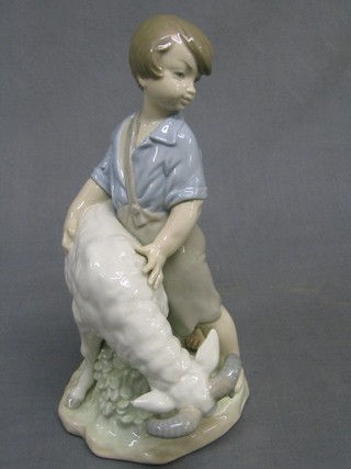A Nao figure of a standing boy with ram, base marked Nao, 9" high