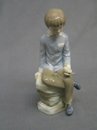 A Zaphir figure of a seated boy with bird 10"