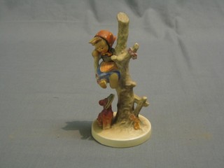 A Hummel figure of a girl in a tree and dog with slipper in mouth 6 1/2"