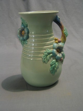 A Clarice Cliff Newport Pottery jug, the handle with floral decoration, the base marked 907 Clarice Cliff Newport Pottery (some crazing to the base) 9"