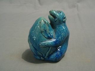 A 19th/20th Century Oriental blue glazed figure of a seated monkey clutching a nut 6"