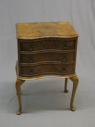 A 1930's walnut Queen Anne style chest of serpentine outline fitted 3 long drawers raised on cabriole feet 20"