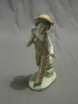 A Nao figure of a walking boy with dog 8"