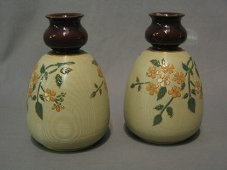 A pair of Victorian pottery club shaped vases with floral decoration 8"