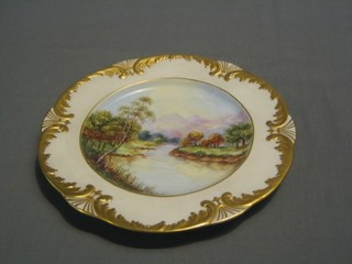 A 19th Century circular porcelain plate the centre painted a mountain river scene by E Pickles, 10"