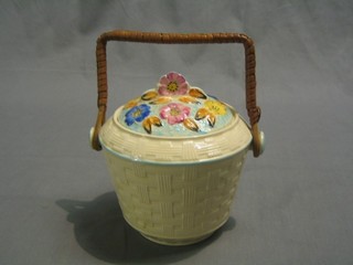 An Art Deco Arthur Woods pottery biscuit barrel with floral decoration