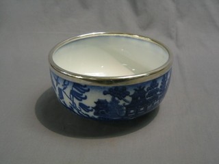 A Mintons blue and white Willow pattern pottery bowl with silver plated rim 10"