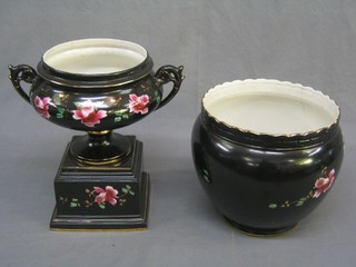 A 19th Century black glazed twin handled and rose pattern jardiniere raised on a square base 11", together with a similar circular jardiniere 8 1/2" (star crack to base)