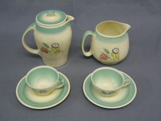 A Susie Cooper hotwater jug decorated flowers, together with a matching jug, 2 cups and 2 saucers