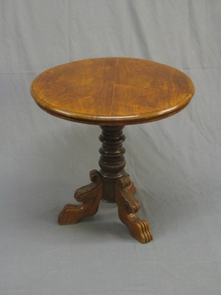 A 19th Century Continental walnut circular occasional table raised on a gun barrel turned column and carved tripod supports 25"