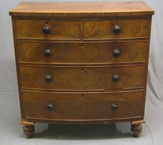 A Victorian mahogany bow front chest of 2 short and 3 long drawers with tore handles raised on bun fet 42"