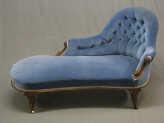 A handsome Victorian carved walnut show frame chaise longue, upholstered in blue  material raised on French cabriole supports 59"