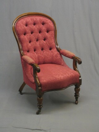 A William IV mahogany open arm chair upholstered in red material raised on turned supports