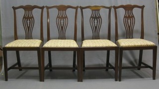 A set of 4 Edwardian mahogany Chippendale style splat back dining chairs with upholstered drop in seats, raised on square supports