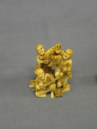 A 19th Century Japanese carved ivory figure group of 2 musicians, gentleman with fan and a street vendor, the base with red seal mark 3 1/2"
