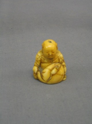 A 19th Century Japanese carved ivory Netsuke of a seated boy with bundle and rat 2"