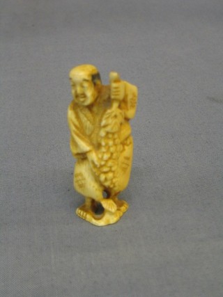 A 19th Century Japanese carved ivory Netsuke of a standing gentleman 2 1/2"