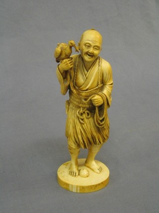 A 19th Century Japanese carved ivory figure of a standing man with bird 8"