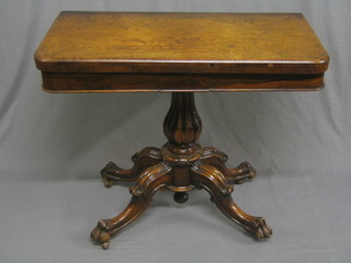 A handsome Victorian rosewood D shaped card table, raised on a turned column and well carved tripod base 36"